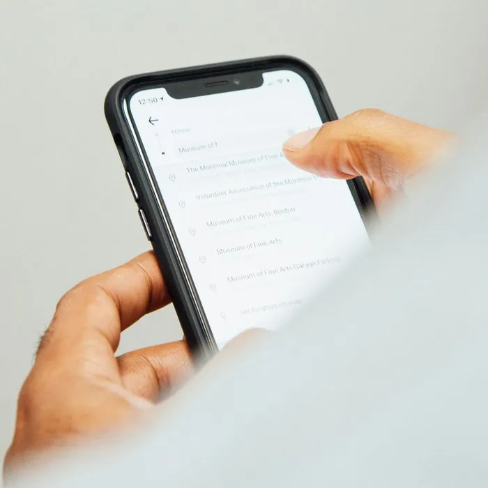 A hand holding a smartphone with a message on the screen